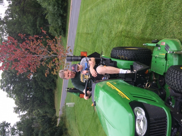 Jeff and Charlie, 2014.  Notice that Charlie is motioning to Grandpa to make sure he mows straight!